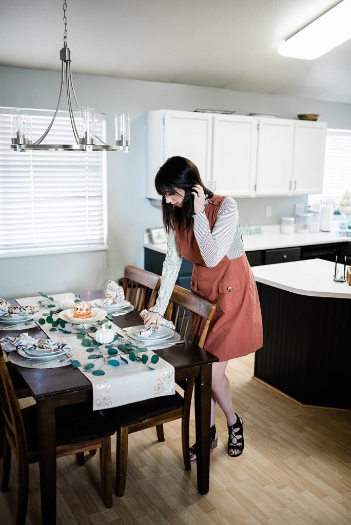 Thanksgiving Day Outfit Idea, featuring rust orange jumper dress, striped mocked turtleneck. This modest outfit is perfect for hosting a holiday dinner and features trendy boutique pieces from My Sister's Closet Boutique. // Hey There, Chelsie