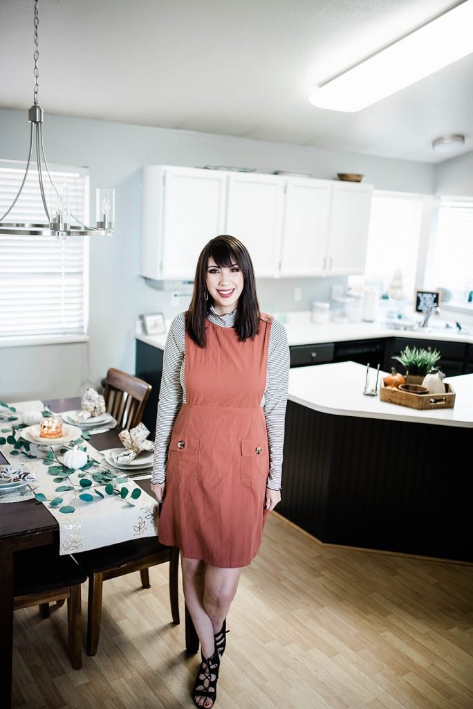 Thanksgiving Day Outfit Idea, featuring rust orange jumper dress, striped mocked turtleneck. This modest outfit is perfect for hosting a holiday dinner and features trendy boutique pieces from My Sister's Closet Boutique. // Hey There, Chelsie