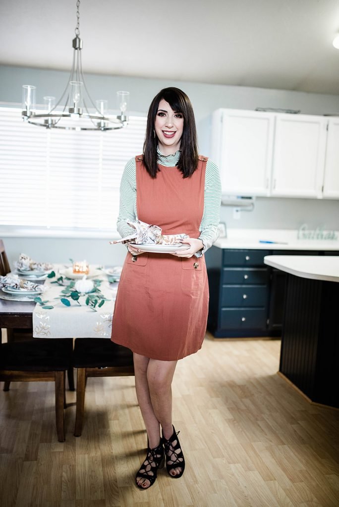 Thanksgiving Day Outfit Idea, featuring rust orange jumper dress, striped mocked turtleneck. This modest outfit is perfect for hosting a holiday dinner and features trendy boutique pieces from My Sister's Closet Boutique. // Hey There, Chelsie